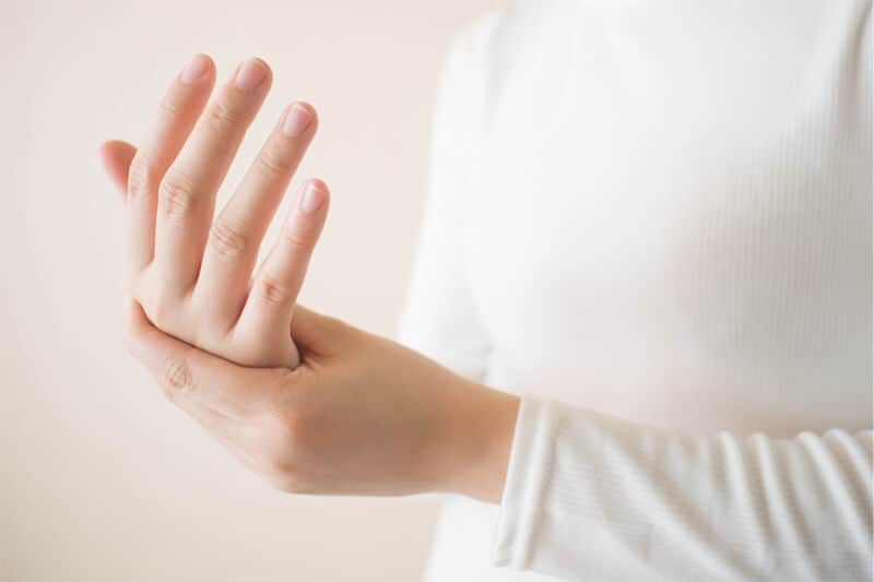 Background image of Caucasian person in white with hand pain