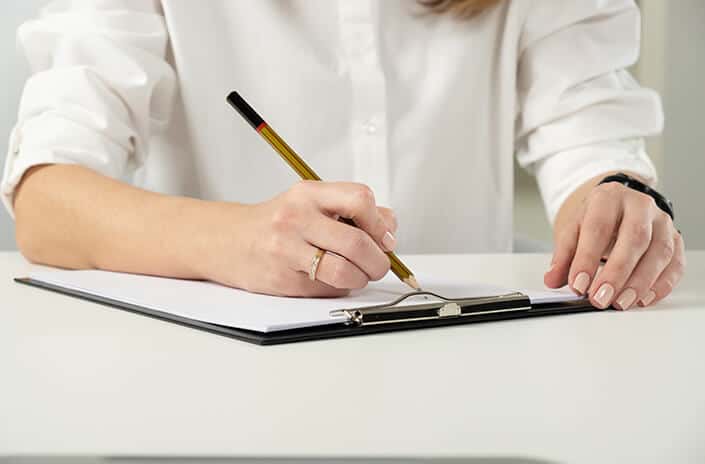 a woman filling out paperwork